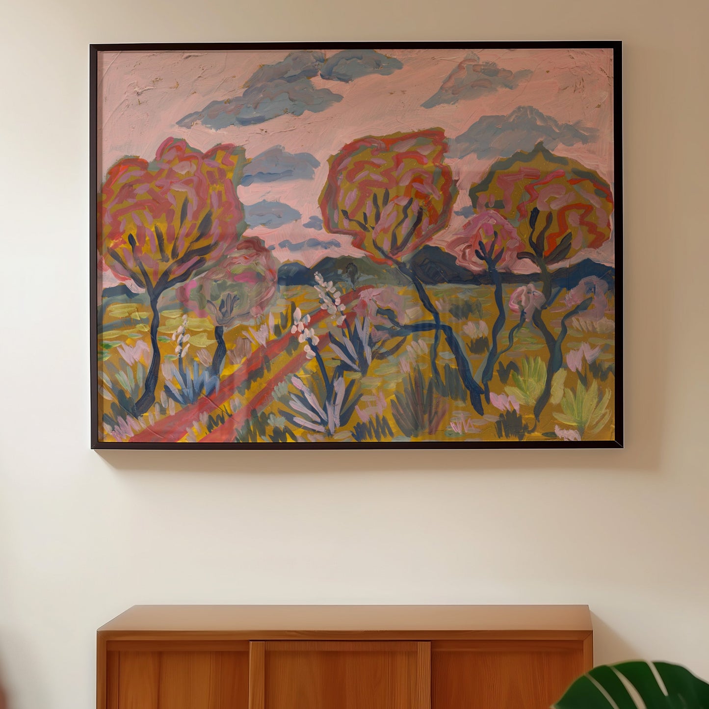 Woman walking past a colorful abstract painting on a wall.